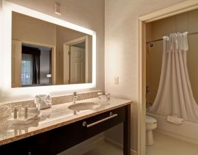 Guest bathroom with shower and tub at Homewood Suites By Hilton Newark-Cranford.