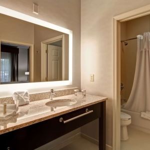 Guest bathroom with shower and tub at Homewood Suites By Hilton Newark-Cranford.