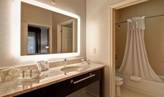 Guest bathroom with shower and tub at Homewood Suites By Hilton Newark-Cranford.