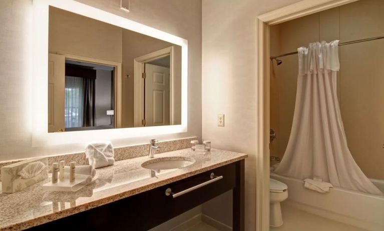 Guest bathroom with shower and tub at Homewood Suites By Hilton Newark-Cranford.