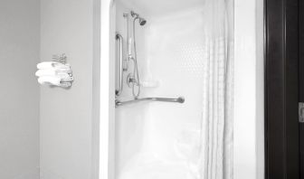 Guest bathroom with shower at Super 8 Bedford DFW Airport West.  