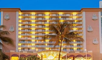 Hotel exterior at night at Ramada Plaza Marco Polo Beach Resort.