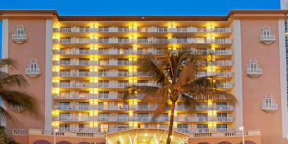 Hotel exterior at night at Ramada Plaza Marco Polo Beach Resort.