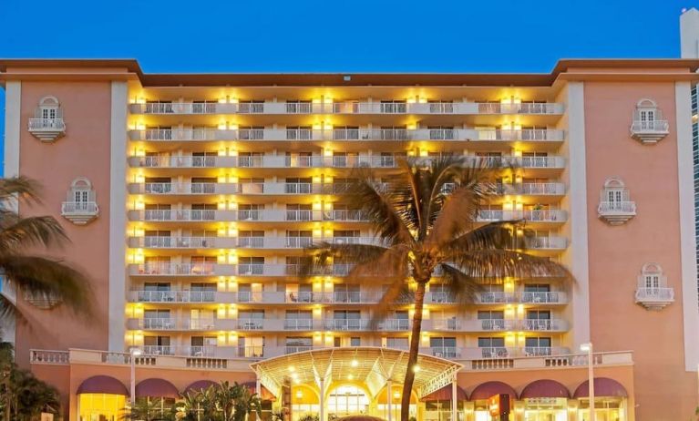 Hotel exterior at night at Ramada Plaza Marco Polo Beach Resort.