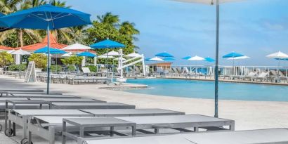 Sun loungers and umbrellas at Ramada Plaza Marco Polo Beach Resort.