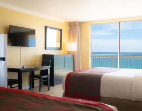 Romantic king room with TV at Ramada Plaza Marco Polo Beach Resort.