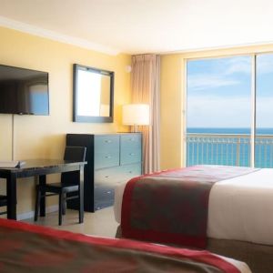 Romantic king room with TV at Ramada Plaza Marco Polo Beach Resort.