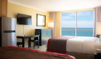 Romantic king room with TV at Ramada Plaza Marco Polo Beach Resort.