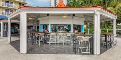 Hotel bar and coworking space at Ramada Plaza Marco Polo Beach Resort.