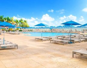 Relaxing pool area at Ramada Plaza Marco Polo Beach Resort.