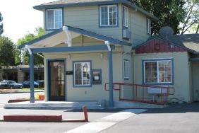 Hotel exterior and parking at North Bay Inn.