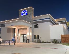 Hotel exterior at night at Palace Inn Blue Jones Rd. 