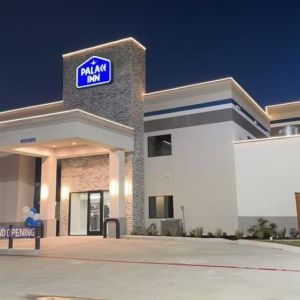 Hotel exterior at night at Palace Inn Blue Jones Rd. 