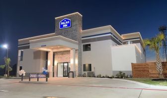 Hotel exterior at night at Palace Inn Blue Jones Rd. 