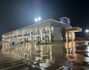 Hotel exterior and parking area at Palace Inn Blue Jones Rd. 