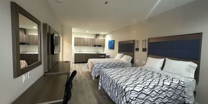 Spacious day room with kitchen area and work station at Palace Inn Blue Jones Rd. 