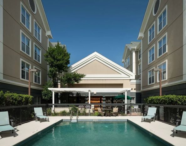 Outdoor pool with sun loungers at Homewood Suites By Hilton Austin NW Near The Domain.