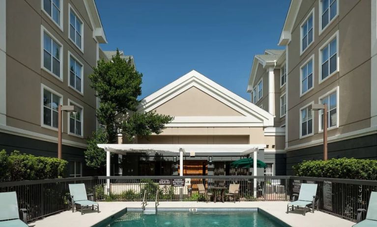 Outdoor pool with sun loungers at Homewood Suites By Hilton Austin NW Near The Domain.