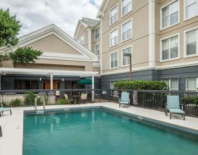 Outdoor pool with loungers at Homewood Suites By Hilton Austin NW Near The Domain.