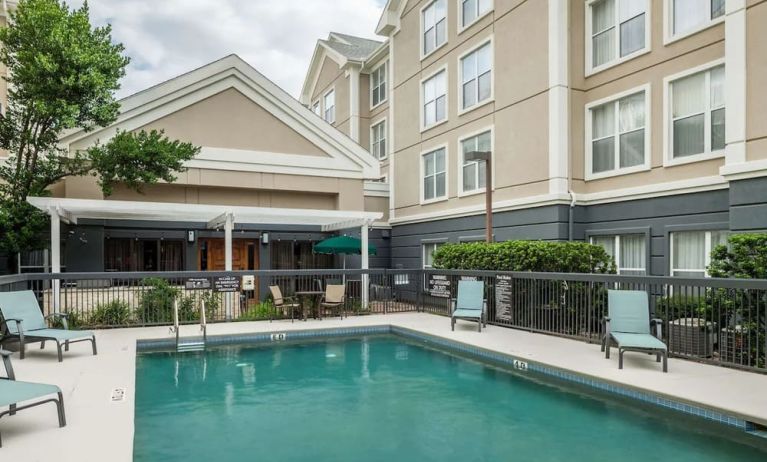 Outdoor pool with loungers at Homewood Suites By Hilton Austin NW Near The Domain.