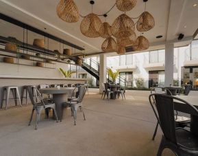 Lounge, bar, and dining area at Lum Hotel Inglewood.