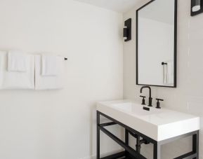 Guest bathroom with shower at Lum Hotel Inglewood.