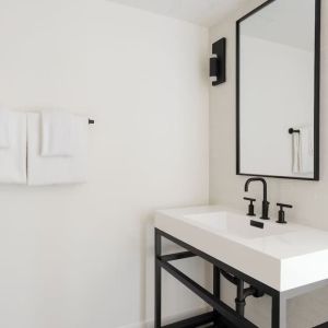 Guest bathroom with shower at Lum Hotel Inglewood.