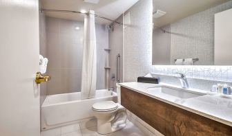 Guest bathroom with shower at Comfort Inn And Suites Calgary South.