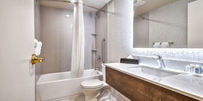 Guest bathroom with shower at Comfort Inn And Suites Calgary South.