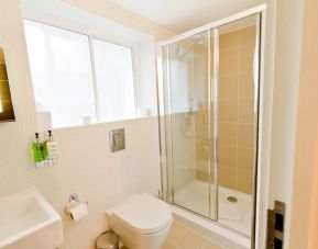 Guest bathroom with shower at The Wesley Euston Hotel.