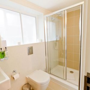 Guest bathroom with shower at The Wesley Euston Hotel.