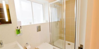 Guest bathroom with shower at The Wesley Euston Hotel.