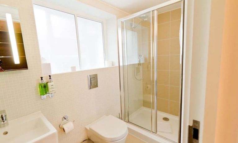 Guest bathroom with shower at The Wesley Euston Hotel.