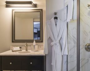 Guest bathroom with shower at The Boxer Boston.