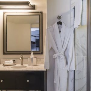 Guest bathroom with shower at The Boxer Boston.