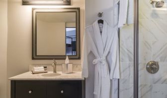 Guest bathroom with shower at The Boxer Boston.