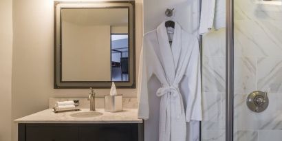 Guest bathroom with shower at The Boxer Boston.