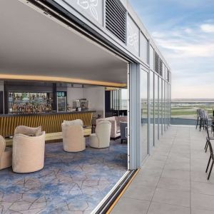 Outdoor chairs near the bar at Hilton Garden Inn London Heathrow Terminals 2 And 3.