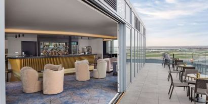 Outdoor chairs near the bar at Hilton Garden Inn London Heathrow Terminals 2 And 3.