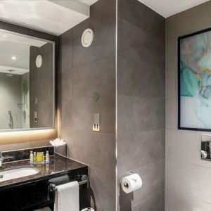 Guest bathroom with shower at Hilton Garden Inn London Heathrow Terminals 2 And 3.