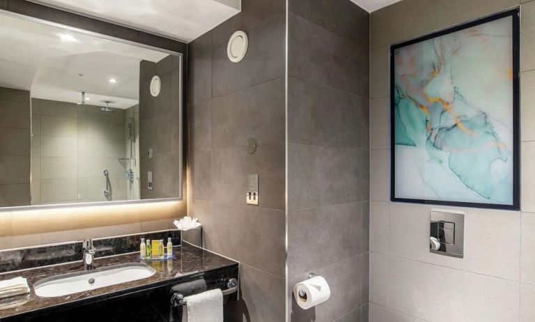 Guest bathroom with shower at Hilton Garden Inn London Heathrow Terminals 2 And 3.