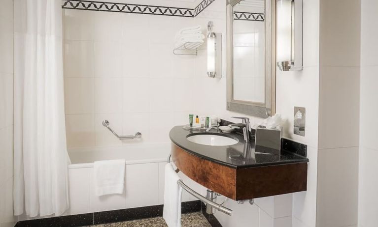 Guest bathroom with shower at Hilton London Paddington.