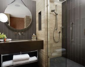 Guest bathroom with shower at Hilton London Bankside. 