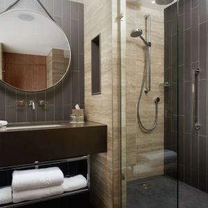 Guest bathroom with shower at Hilton London Bankside. 