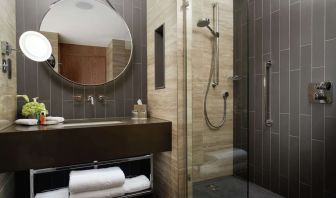 Guest bathroom with shower at Hilton London Bankside. 