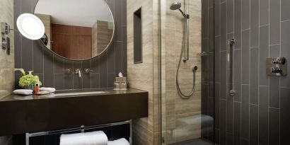 Guest bathroom with shower at Hilton London Bankside. 