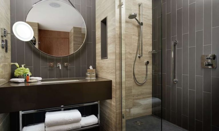 Guest bathroom with shower at Hilton London Bankside. 