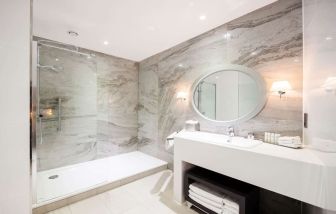 Guest bathroom with shower at DoubleTree By Hilton Edinburgh City Centre.