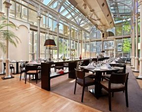 Dining area with natural light at Hilton London Euston.