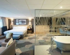 Spacious day use room with living area and tub at DoubleTree By Hilton Coventry Building Society Arena.